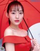 A woman in a red dress holding an umbrella.